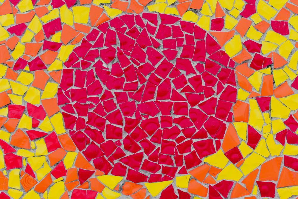 rote und gelbe Papierschnipsel zu einem Kreis gelegt