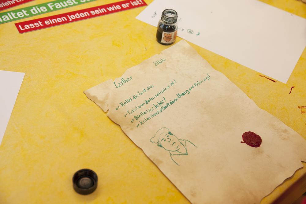 gelbe Tischdecke, altes Papier, grüne Tinte, Tintenfässchen